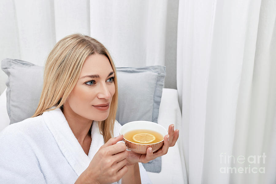 Woman Drinking Tea At A Spa #1 Photograph by Peakstock / Science Photo Library