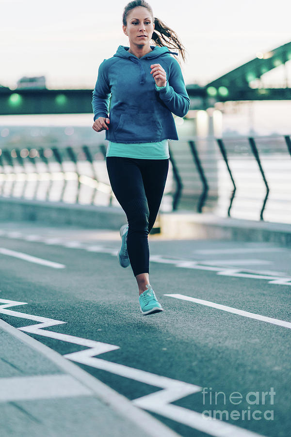 Woman Jogging In City At Night #1 by Microgen Images/science Photo Library