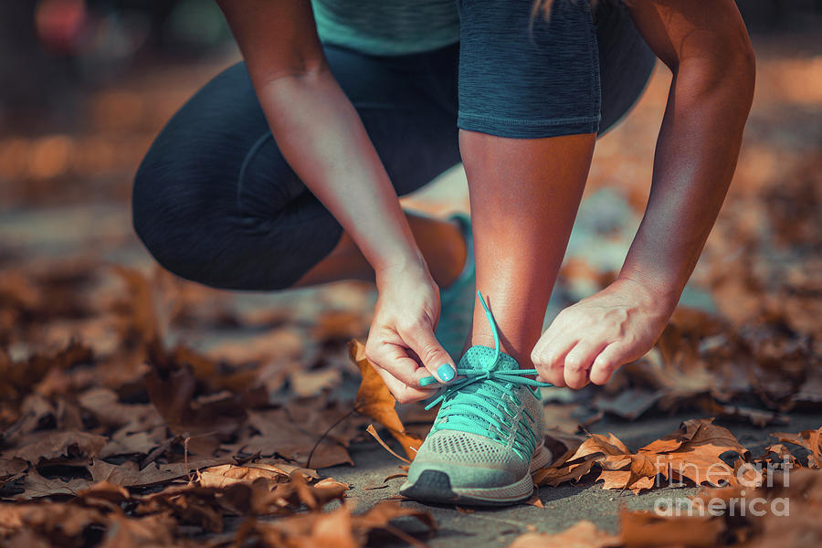 Woman Kneeling And Tying Shoe #1 Photograph by Microgen Images/science Photo Library