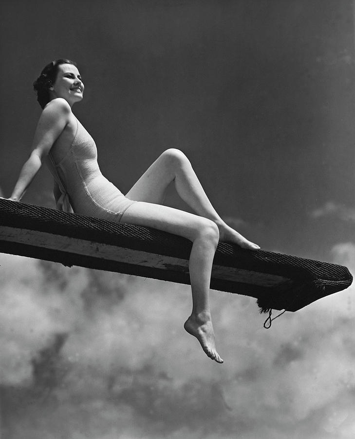Woman Sitting On Divingboard #1 Photograph by George Marks