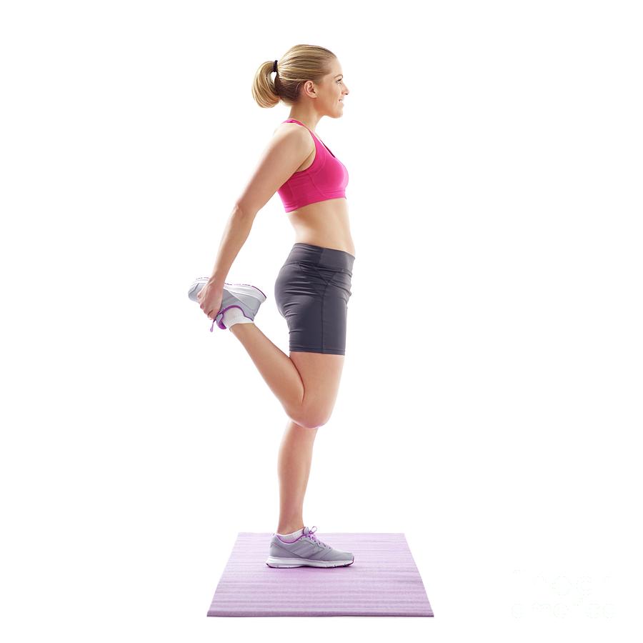 Woman Stretching Quad Muscles Photograph By Science Photo Library