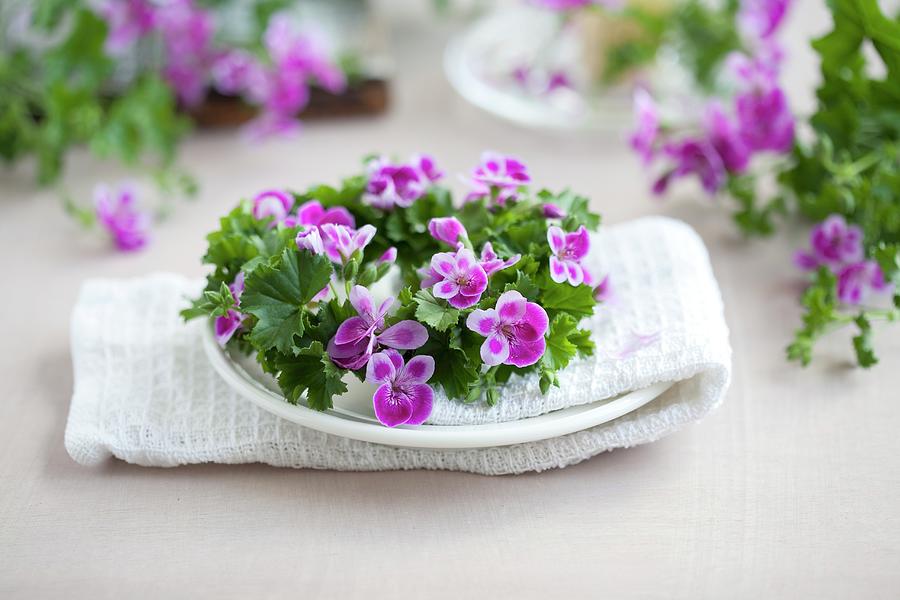 Wreath Of Scented Pelargoniums Decorating Table #1 Photograph by Martina Schindler