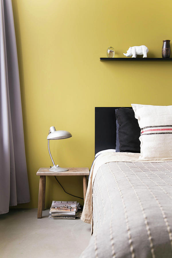 Yellow Wall Behind Bed In Bedroom #1 Photograph by Ilaria Chiaratti