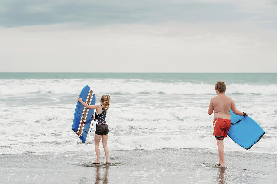 Young Boy And Girl With Boogie Boards At The Beach Photograph by Cavan ...