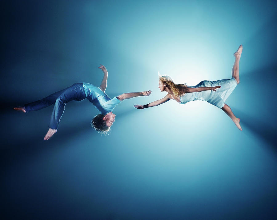Young Couple In Air, Low Angle View #1 Photograph by Henrik Sorensen