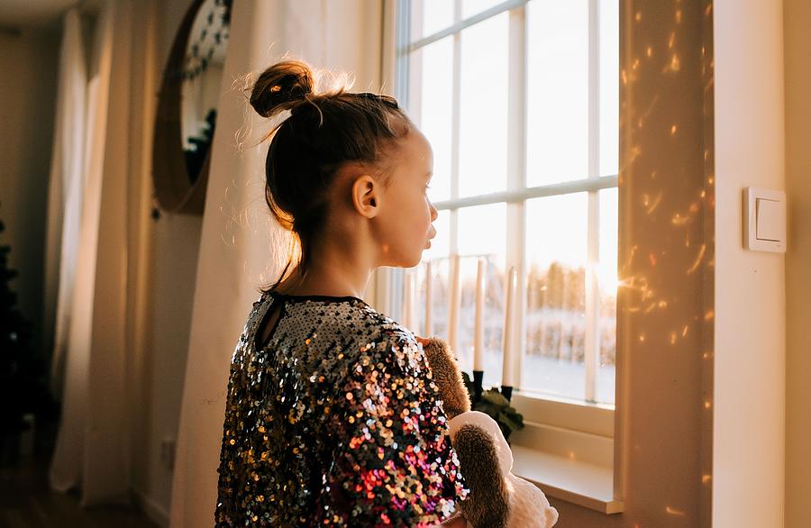Sunset Photograph - Young Girl Playing With Her Toy At Home In A Sparkly Dress At Sunset #1 by Cavan Images