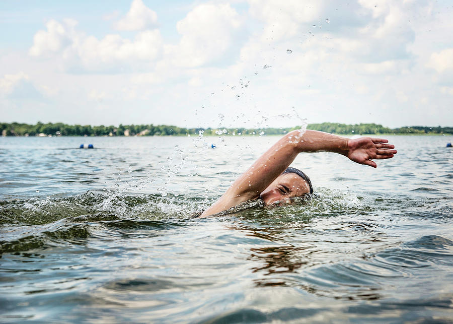 Young Girl Swimming In A Lake Photograph by Cavan Images - Fine Art America