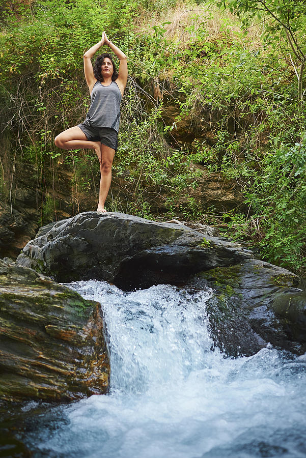 Nature Photograph - Young Woman Practicing Yoga In A River. Shes In The Middle Of Nature. #1 by Cavan Images