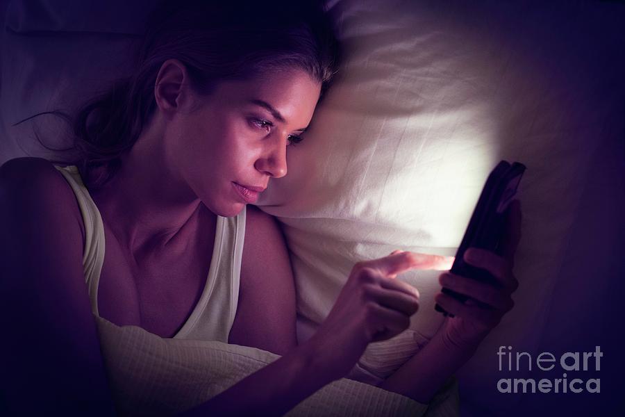 Young Woman Using Digital Tablet In Bed Photograph By Ian Hooton