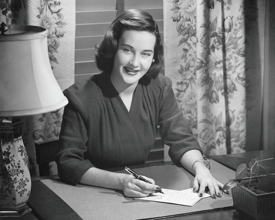 Black And White Photograph - Young Woman Writing Letter At Desk, B&w #1 by George Marks