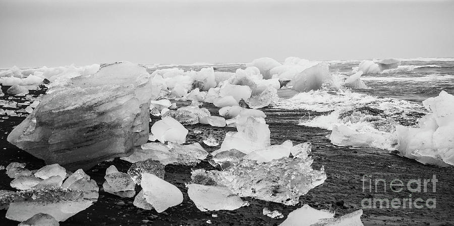 Giant ice blocks detached from icebergs on the coast of an Icelandic beach. #10 Photograph by Joaquin Corbalan