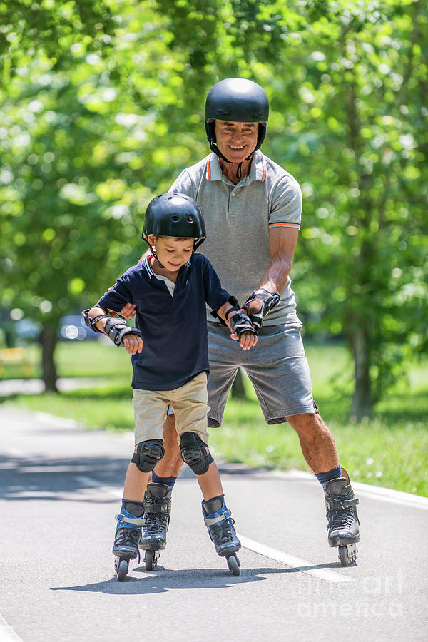 Summer Photograph - Grandfather Teaching Grandson To Roller Skate #11 by Microgen Images/science Photo Library