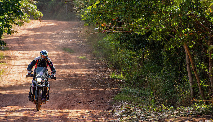 Rural Scene Photograph - Man Riding His Adventure Motorbike On Dusty Road In Cambodia #12 by Cavan Images