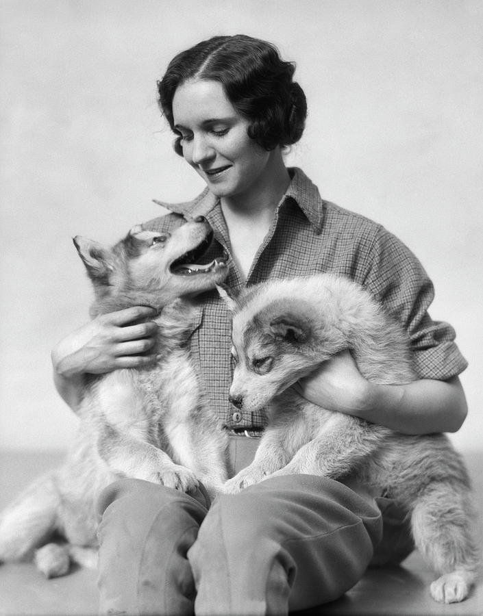 1920s 1930s Smiling Woman Holding Two Photograph by Vintage Images - Pixels