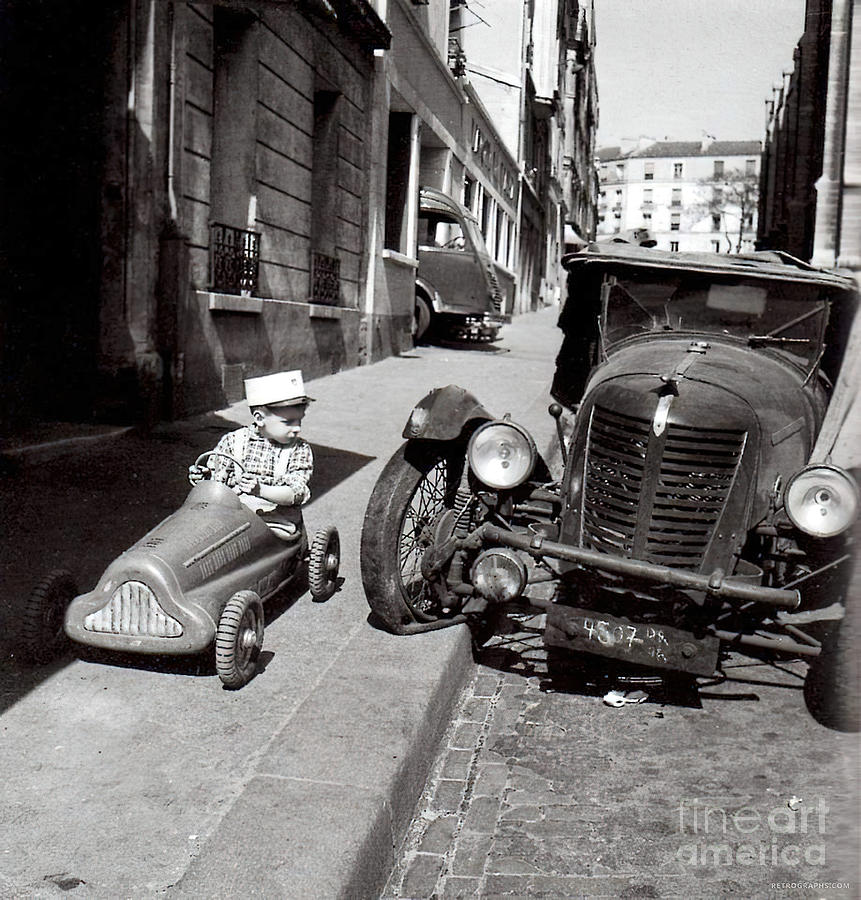 1930s Street Scene With Child In Pedal Car And Vehicle With Flat Tire Photograph by Retrographs