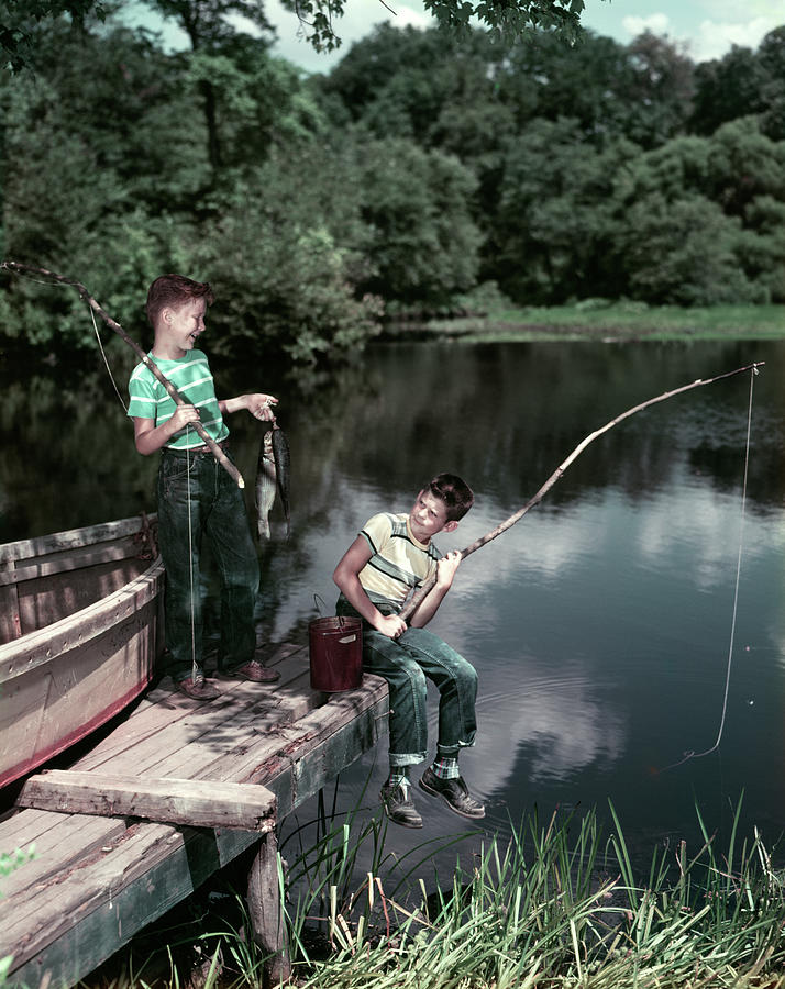 1950s Two Boys Fishing In Lake by Vintage Images