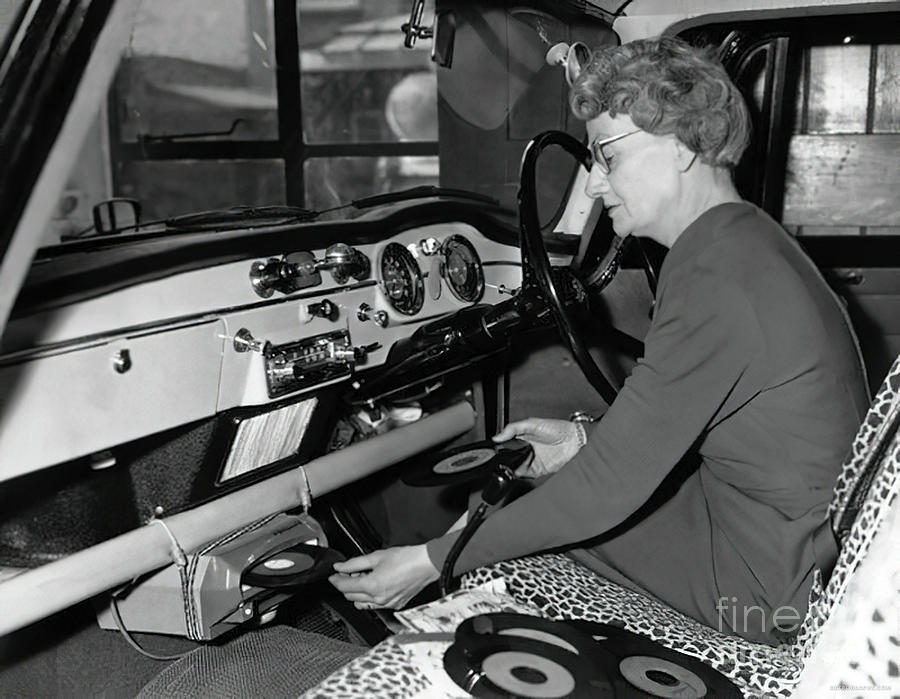 1950s Woman Demonstrating Vehicle Record Player Photograph by Retrographs