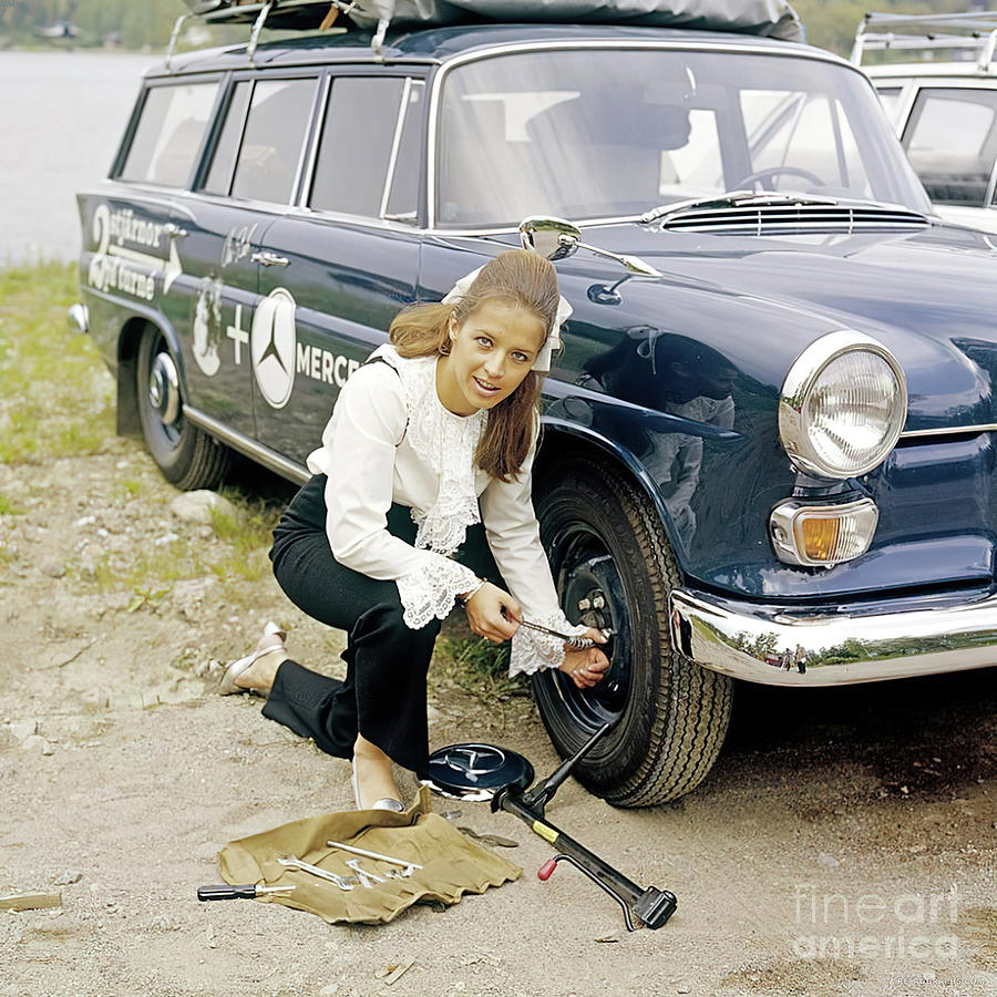 1960s Woman Changing Tire Of Mercedes 200 Station Wagon Photograph by Retrographs