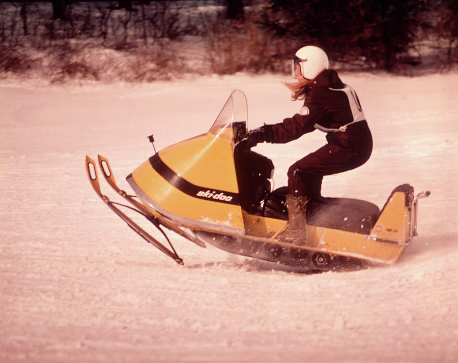 Sports Painting - 1970s Woman Driving Yellow Skidoo by Vintage Images