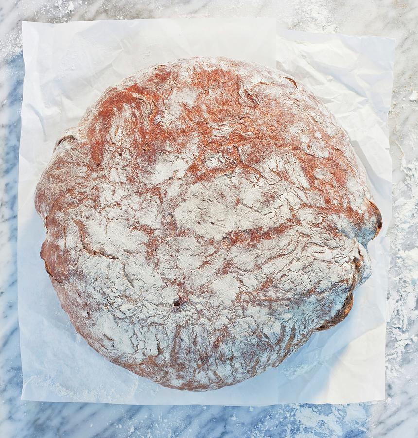 A Loaf Of Bread On Paper, On A Marble Slab, Dusted With Flour #2 Photograph by Achmann, Andreas