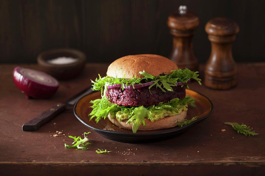 A Veggie Burger With A Beetroot Patty And Avocado Spread #2 Photograph by Olga Miltsova