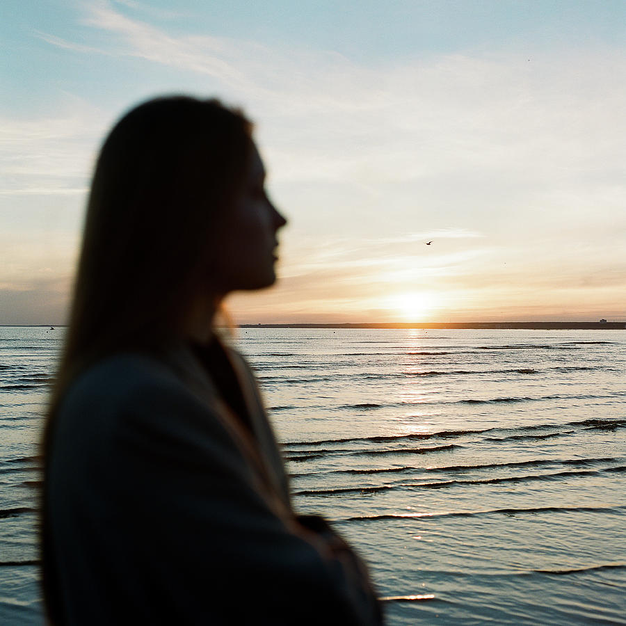 Beautiful Woman Standing Near The Sea And Enjoying The Sunset ...