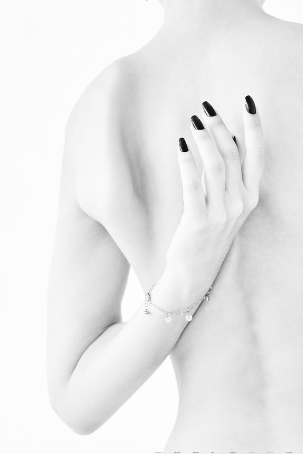 Body Parts Of A Naked Girl Torso And Hand Pressing Her Breasts With A Black Manicure On Her Nails #2 Photograph by Alexandr