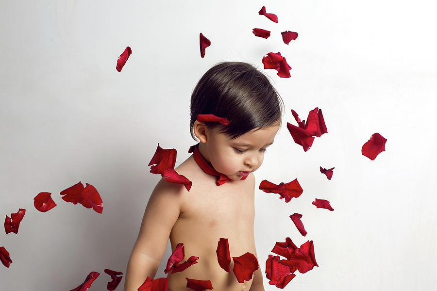 Child Without A T-shirt Sitting On A White Background Photograph