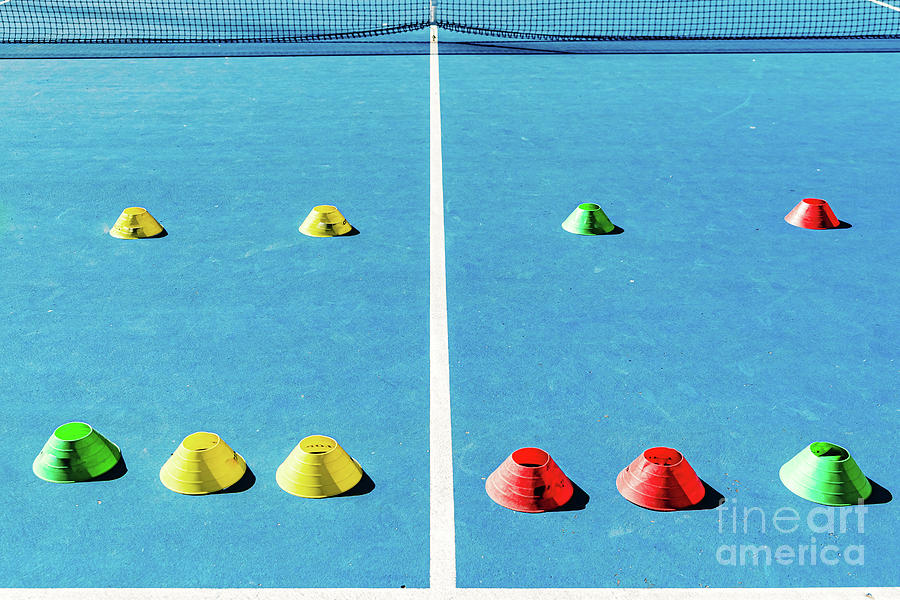 Colorful plastic cones on a blue cement tennis court with white  #2 Photograph by Joaquin Corbalan
