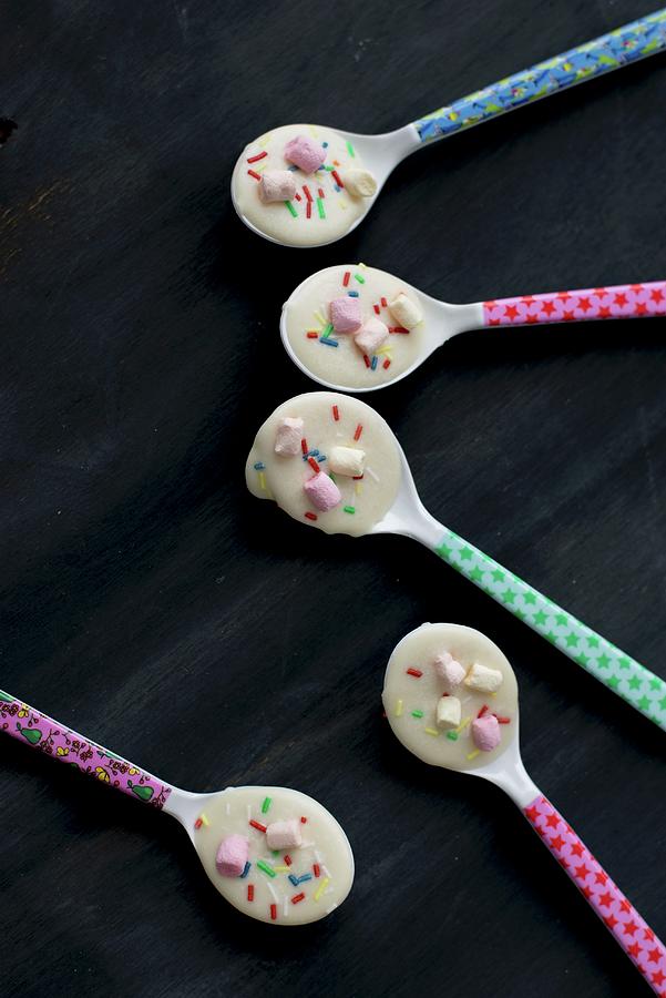 Colourful Spoons Covered With White Chocolate And Bright Hundreds And Thousands #2 Photograph by Ulla@patsy