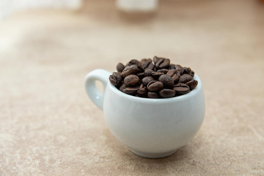Coffee Photograph - Cup of coffee full of coffee beans #2 by Alexandr Marynkin
