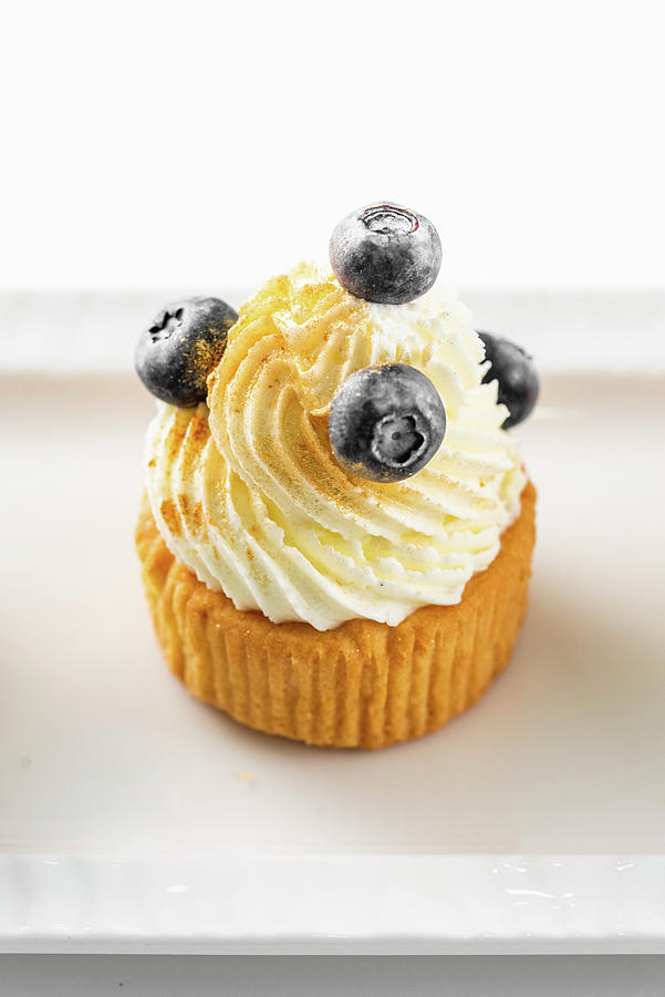 Cupcake With Buttercream And Blueberries #2 Photograph by Kuzmin5d