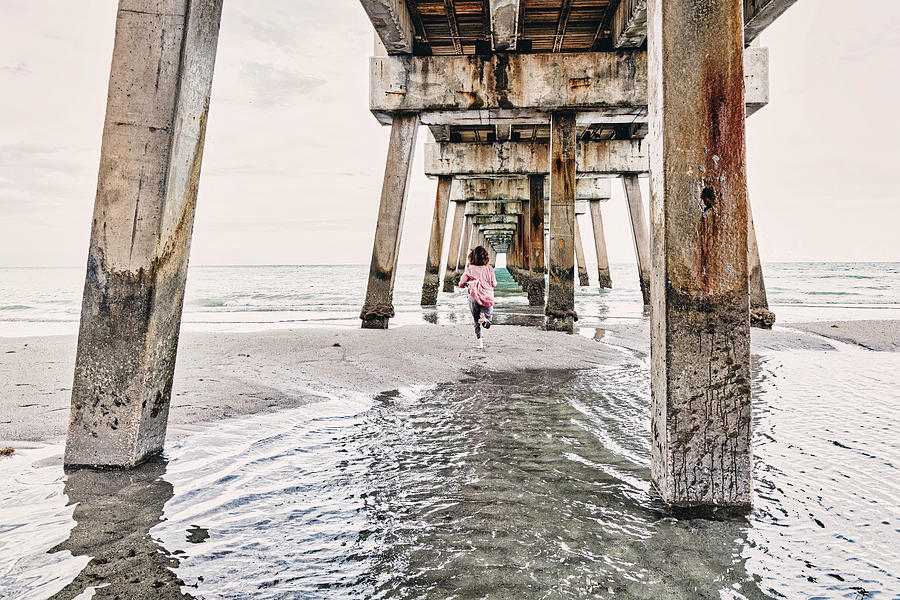 Juno Digital Art - Florida, South Florida, Woman Running Under The Juno Beach Pier #2 by Laura Diez