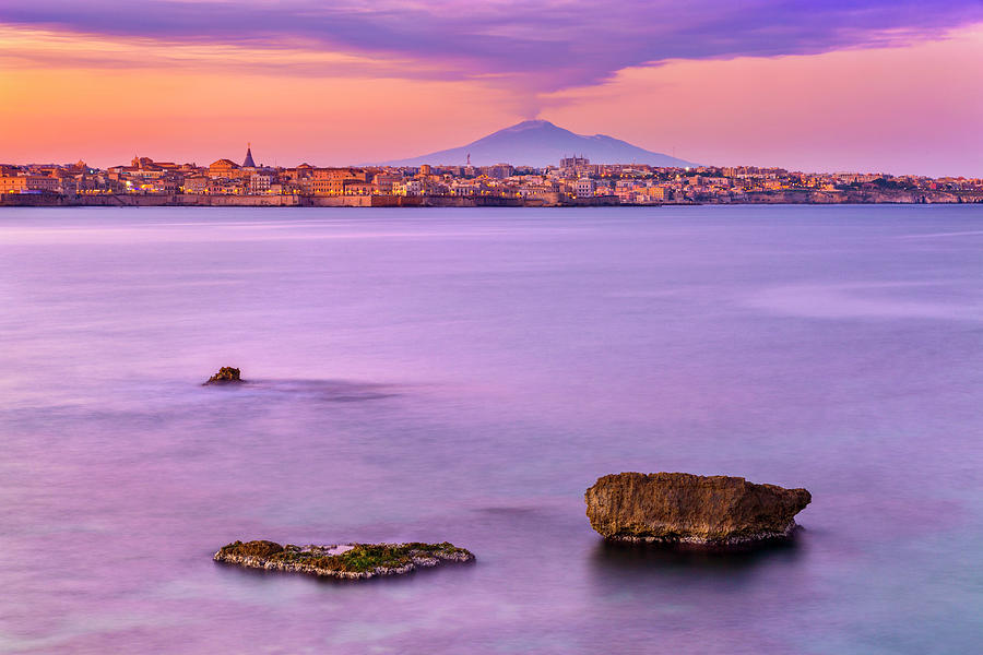 Italy, Sicily, Siracusa District, Ionian Coast, Mediterranean Sea, Ionian Sea, Siracsyracuse And The Etna Volcano Erupting In The Background Seen From The Plemmirio Protected Marine Area #2 Digital Art by Luca Scamporlino