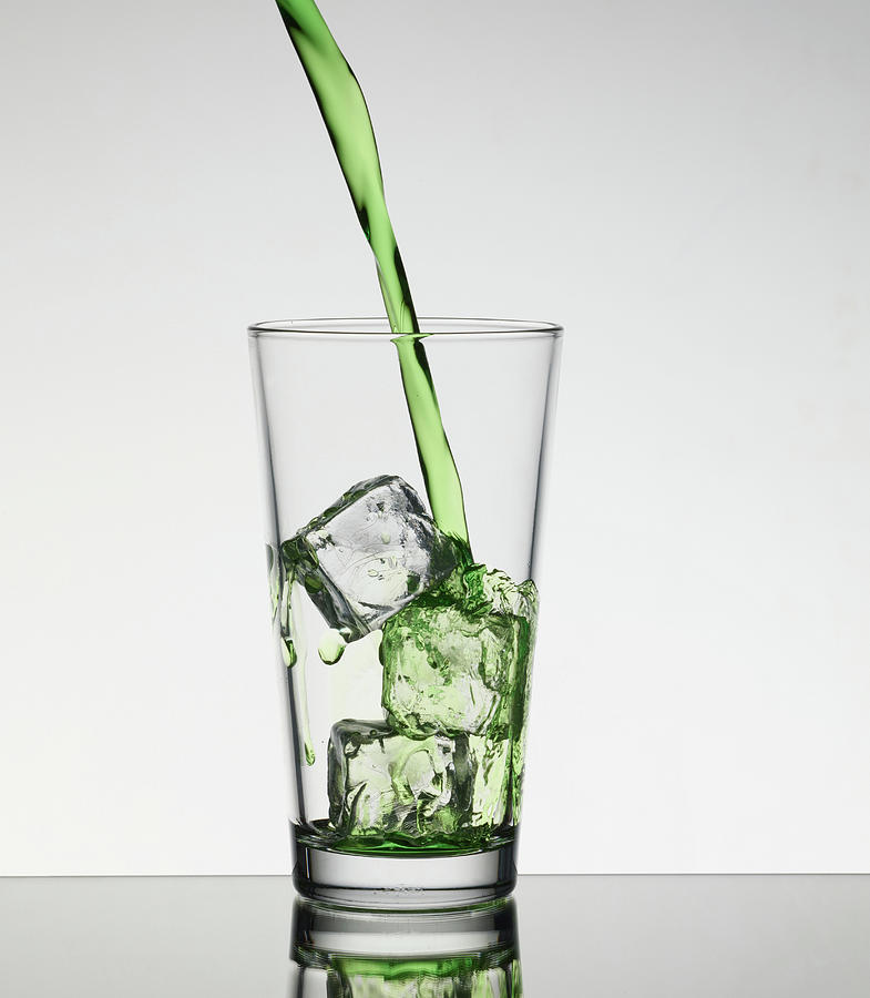 Glass Of Ice Cubes In Fizzy Drink by Walter Zerla