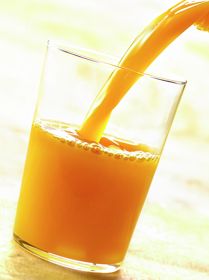 Jus D'orange Pouring A Glass Of Orange Juice Photograph by Studio ...