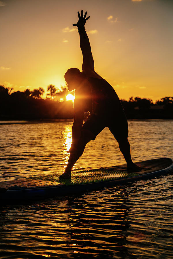 Man Doing Yoga On His Standup Paddle Board Photograph by Cavan Images ...