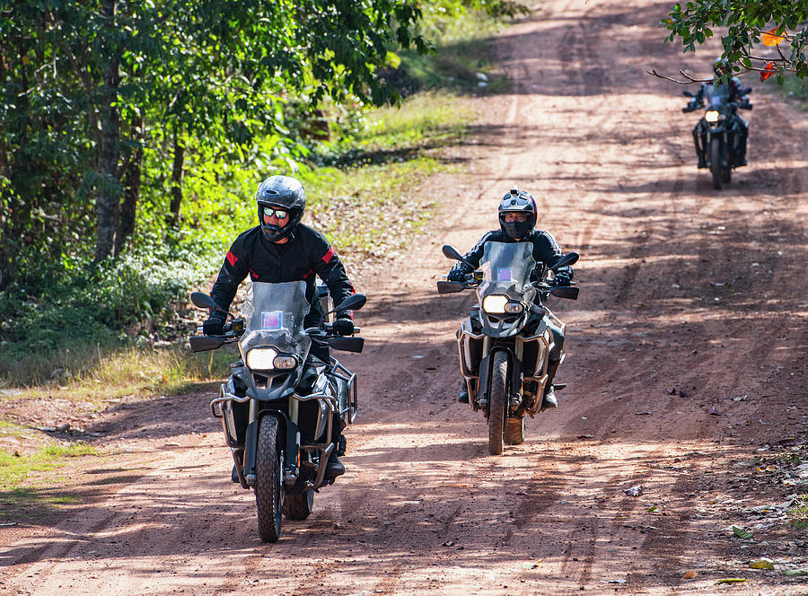 Rural Scene Photograph - Men Riding Their Adventure Motorbikes On Dusty Road In Cambodia #2 by Cavan Images