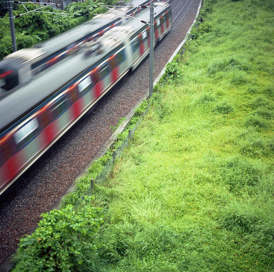 2 Moving Trains Passing Through A Grass Photograph by Kevin Liu