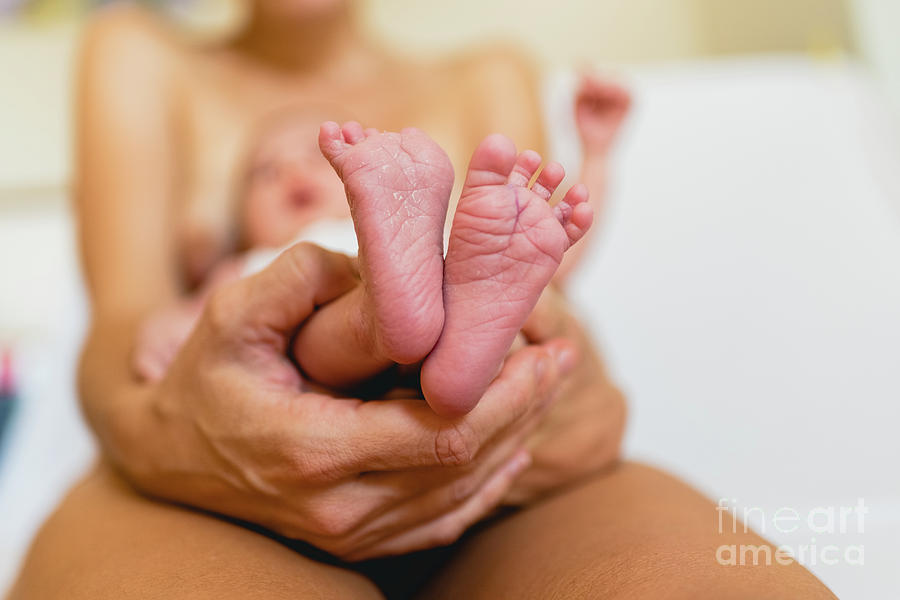 Newborn feet skinning held by mommy #2 Photograph by Joaquin Corbalan