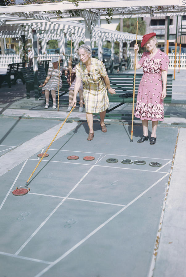 2 Old Women Play Shuffle Board, 1940s Photograph by Archive Holdings Inc. 2 Old Women Play Shuffle Board, 1940s Photograph by Archive Holdings Inc.