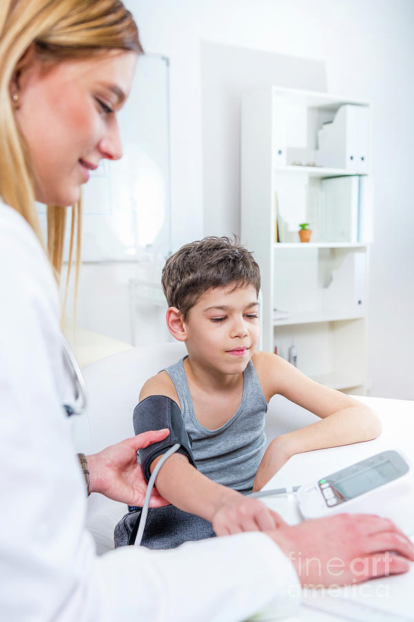 Paediatrician Measuring Boys Blood Pressure Photograph By Microgen
