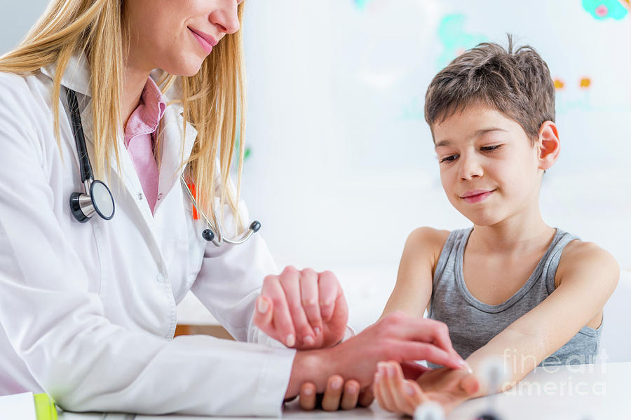 Paediatrician Measuring Boy's Heart Rate Photograph by Microgen Images ...