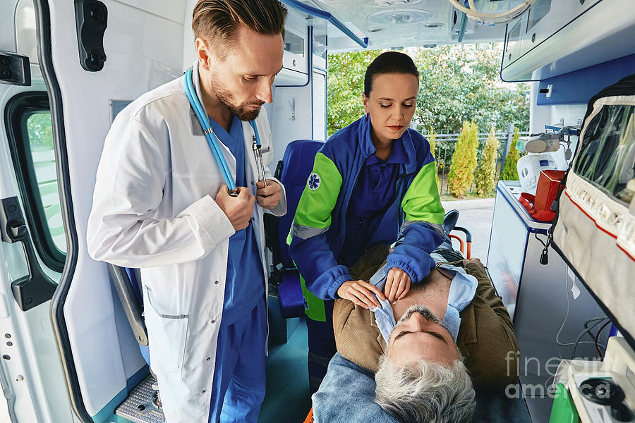 Patient Being Treated In The Back Of An Ambulance Photograph by ...