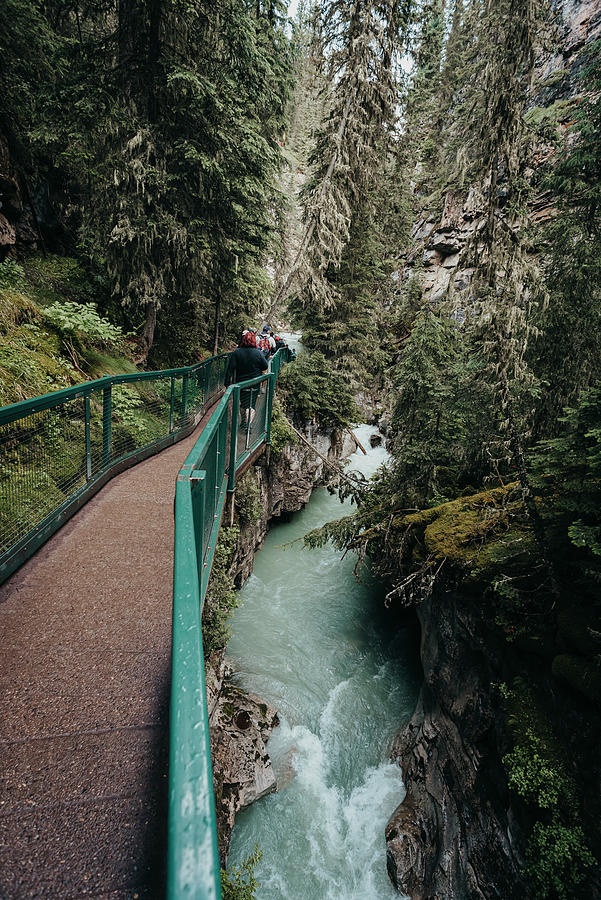 Banff National Park Photograph - People Walking On Metal Catwalk Alongside The Flowing Water In Canyon. #2 by Cavan Images