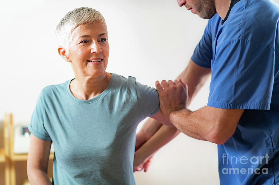 Physical Therapist Examining Patients Arm #2 Photograph by Microgen Images/science Photo Library