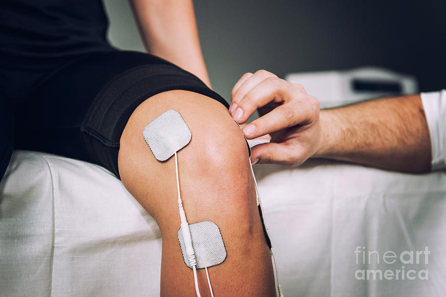 Placing Tens Electrodes On Knee Photograph by Microgen Images/science