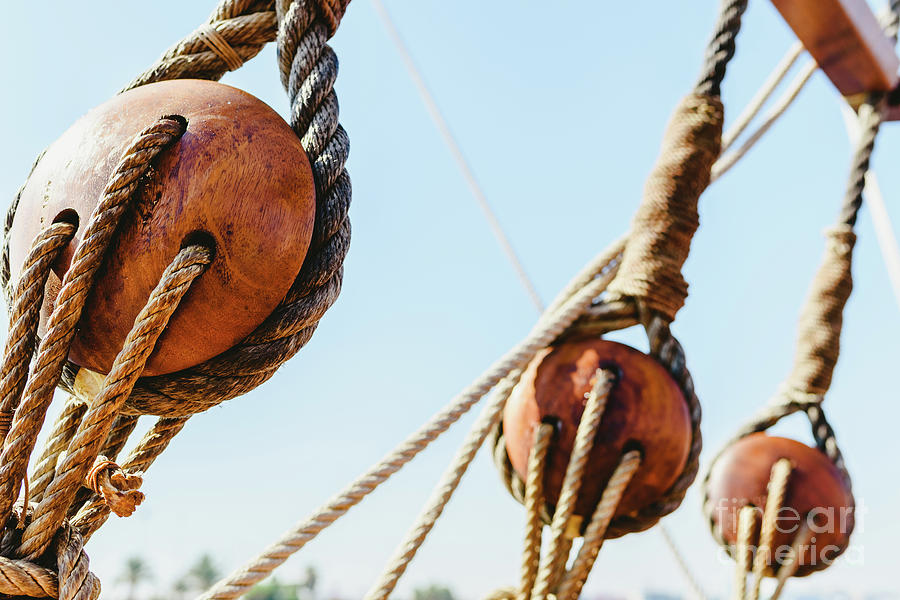 Rigging and ropes on an old sailing ship to sail in summer. #2 Photograph by Joaquin Corbalan