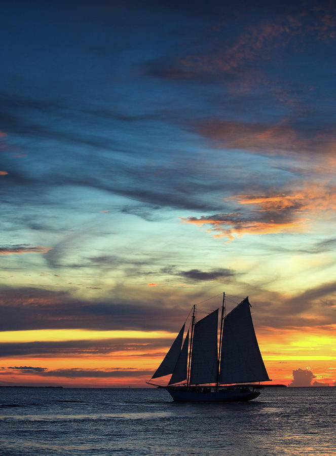 Sailboat At Sunset Photograph by Thepalmer