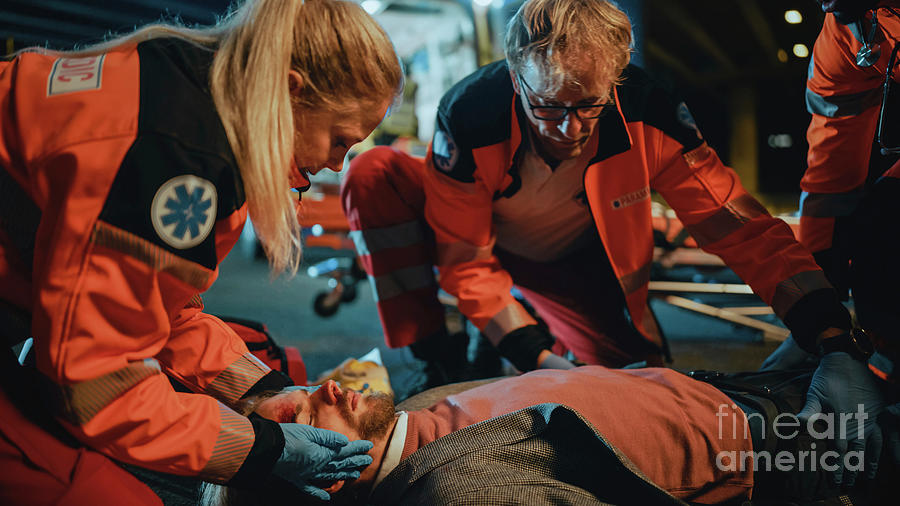 Team Of Paramedics Providing Medical Help #2 Photograph by Gorodenkoff Productions/science Photo Library
